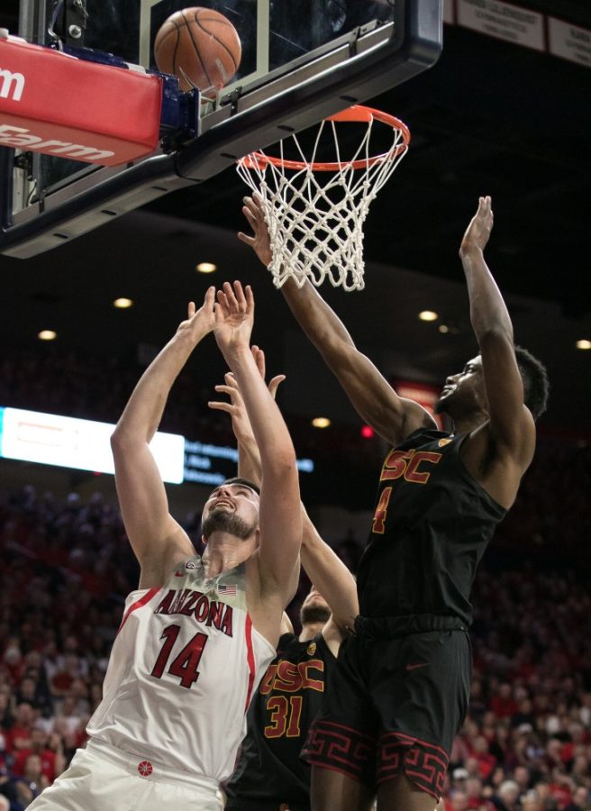 Arizonas Dusan Ristic lays in the ball past USCs Chimezie Metu (4) during the second half of the UA-USC game on Saturday, Feb. 10 at McKale Center in Tucson, Ariz.
