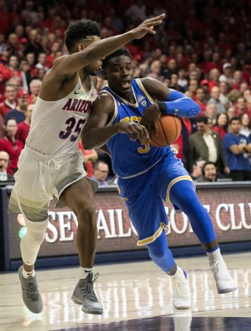 UCLA's Aaron Holiday (3) drives past Arizona's Allonzo Trier (35) before the half of the UA-UCLA game on Thursday, Feb. 8 at McKale Center in Tucson, Ariz. At the half, Arizona trails 44-34.