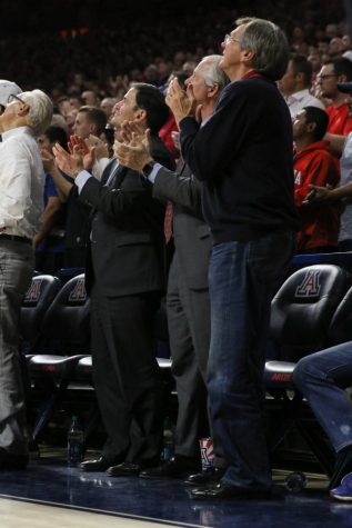 President Dr. Robbins, Gov. Doug Ducey, left, and Jim Click, right, stand court side at the Arizona basketball game against the UCLA Bruins on Thursday, Feb. 8.