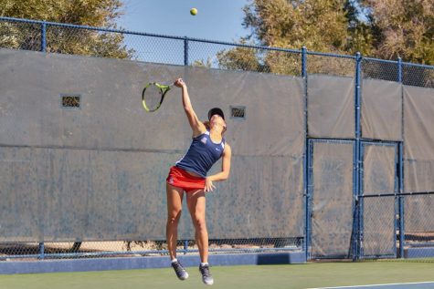 Arizon's Tayla Zandberg jumps up to serve the ball hard at her opponent during a match vs The University of Houston on Feb. 11, at the Robson Tennis Center, in Tucson, Ariz.