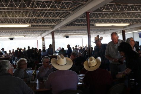 Spectators gather together to have drinks and place bets on the horses at Rillito Racetrack's opening weekend on Feb. 10 and 11.