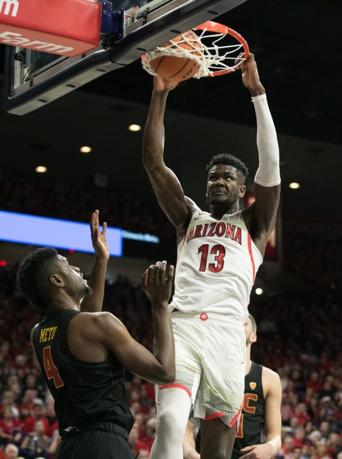 Arizonas Deandre Ayton (13) dunks over USCs Chimezie Metu (4) during the second half of the UA-USC game on Saturday, Feb. 10 at McKale Center in Tucson, Ariz. Ayton had 18 points and seven rebounds in the game.