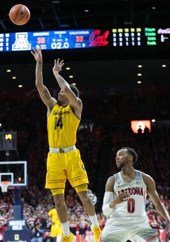University of California's Don Coleman (14) takes a shot past Arizona's Parker Jackson-Cartwright (0) in the first half of the Arizona-Cal game on Saturday, March 3 in McKale Center.