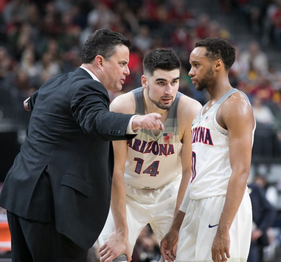 Arizona seniors Dusan Ristic (14) and Parker Jackson-Cartwright (0) share final words with head coach Sean Miller late in the Arizona-USC Championship game at the 2018 Pac-12 Tournament on Saturday, March 10 in T-Mobile Arena in Las Vegas, Nev.