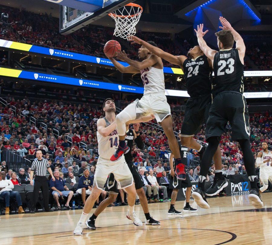 Arizonas Allonzo Trier (35) lays in the ball past Colorados George King (24) and Lucas Siewert (23) in the second half of the Colorado-Arizona Quarterfinal game at the 2018 Pac-12 Tournament on Thursday, March 8 in T-Mobile Arena in Las Vegas, Nev. Trier had 22 points and three assists in the game.
