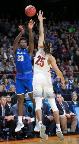 Buffalo's Nick Perkins (33) shoots over Arizona's Keanu Pinder (25) in the first half of the Arizona-Buffalo game in the first round of the NCAA Tournament on Thursday, March 15 in Boise, Idaho.