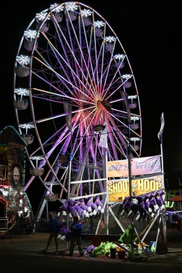The ferris wheel and a booth game at the Pima County Fair on April 23, 2016.