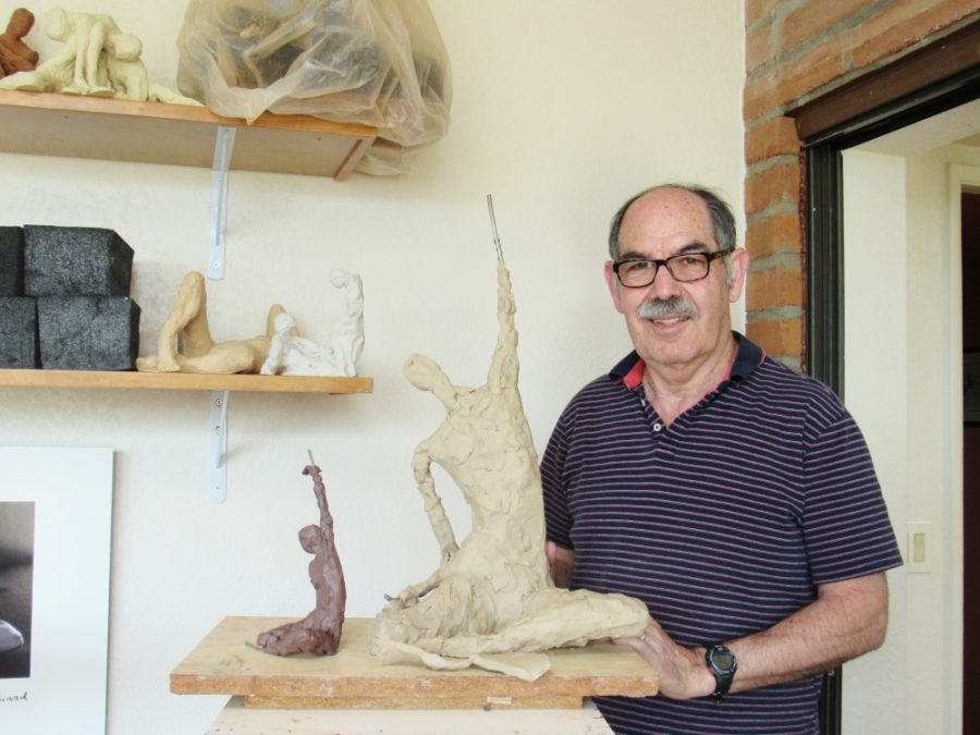 Neil Weinstein posing with his most current work in his in house studio in Tucson, Ariz.