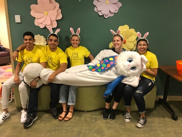 Members of Project Sunshine pose with the Easter Bunny during the TMC Childrens Clinics Spring Festival event.