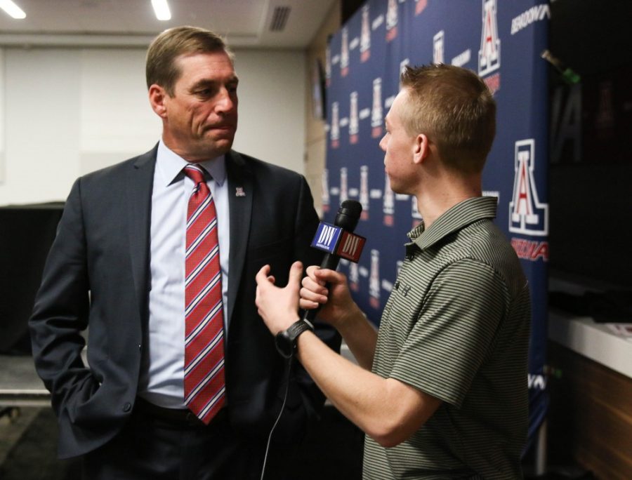 UA+athletic+director%2C+Dave+Heeke%2C+gets+interviewed+by+Alec+White%2C+a+reporter+for+the+Daily+Wildcat%2C+before+the+start+of+a+press+conference+held+on+Tuesday%2C+Jan.+16.