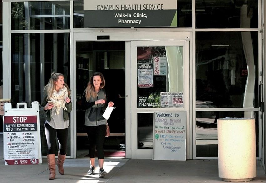 Nutritional sciences students Kiersten Kunkle, left, and Macie Andrews, right, walk out of the Campus Health Center.