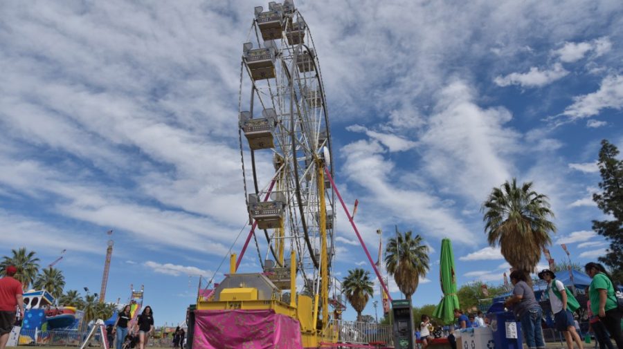 The ferris wheel towers above attendees as they mill around before the fun begins during Spring Fling 2017. Spring Fling is an annual campus fair put on in the spring semester. 