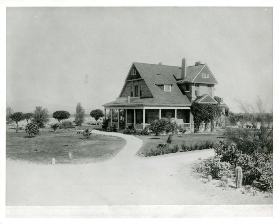 View of UA presidents home from the east side with the Tucson Mountains in the background circa 1896. A mature cactus garden can be seen in the right corner.