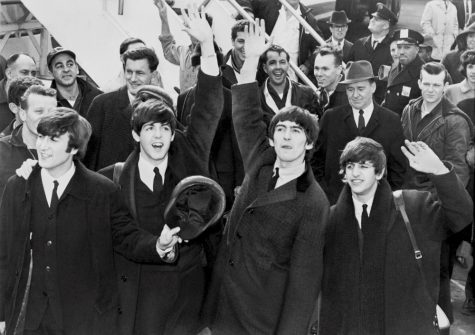 The Beatles, a popular band from England during the 60's and 70's, wave to the crowd. The Beatles are remembered as one of the most influential bands of all time.