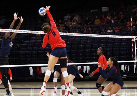   Kendra Dahlke (8) spikes the ball as the defenders attempt to block her at the Volleyball Red-Blue match on Aug. 18, 2018. The Wildcats host a total of 16 home matches in McKale Center this season. 