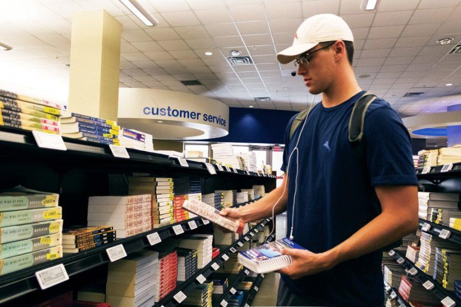 August Kelly, a freshman pre-business major, picks up a book for one of his classes in the UA Bookstore on Monday, Aug. 31. The bookstore is located in SUMC.