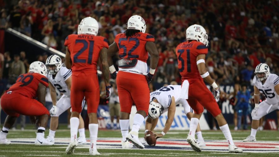 PJ+Johnson+%2852%29+stands+near+the+line+of+scrimmage+before+the+ball+is+snapped+during+the+Arizona+vs+BYU+game+on+Sept.+1%2C+2018+at+Arizona+Stadium.