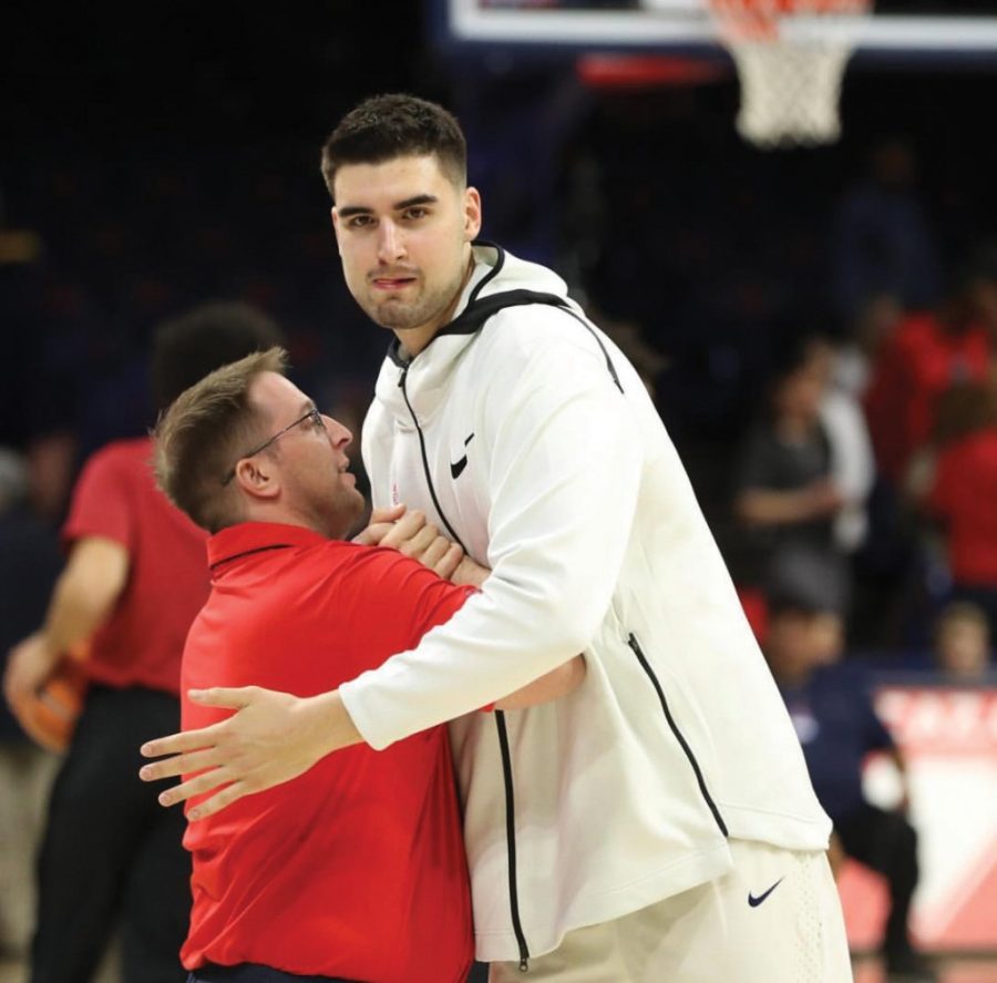 Brian+Brigger+%28left%29+embraces+Arizona+mens+basketball+player+Dusan+Ristic+%28right%29+during+warmups+at+the+McKale+Center.