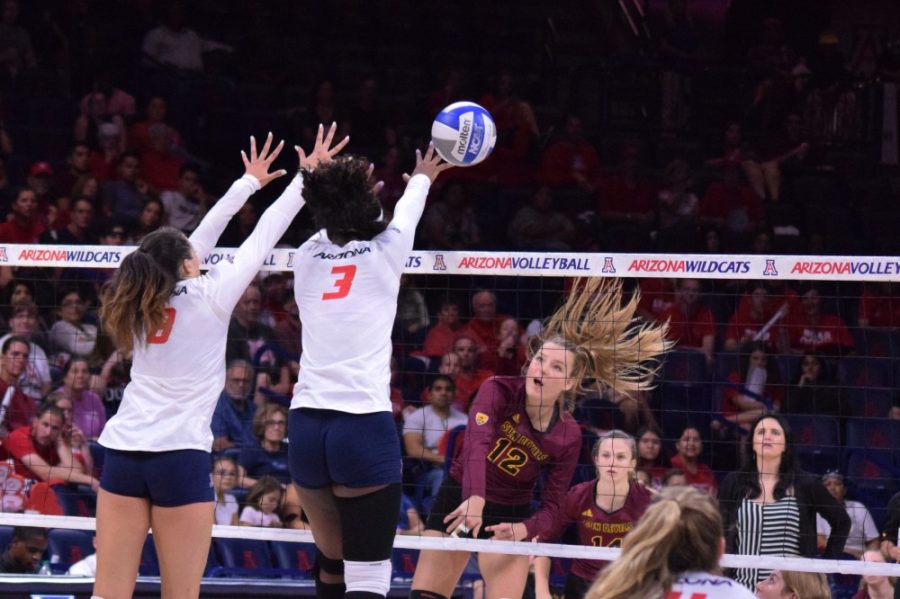 Players Kendra Dahlke (8) and Shardonee Hayes (3) block a set from Arizona State University. This year, the ZonaZoo introduced a new chant related to the girls volleyball team’s blocking abilities.