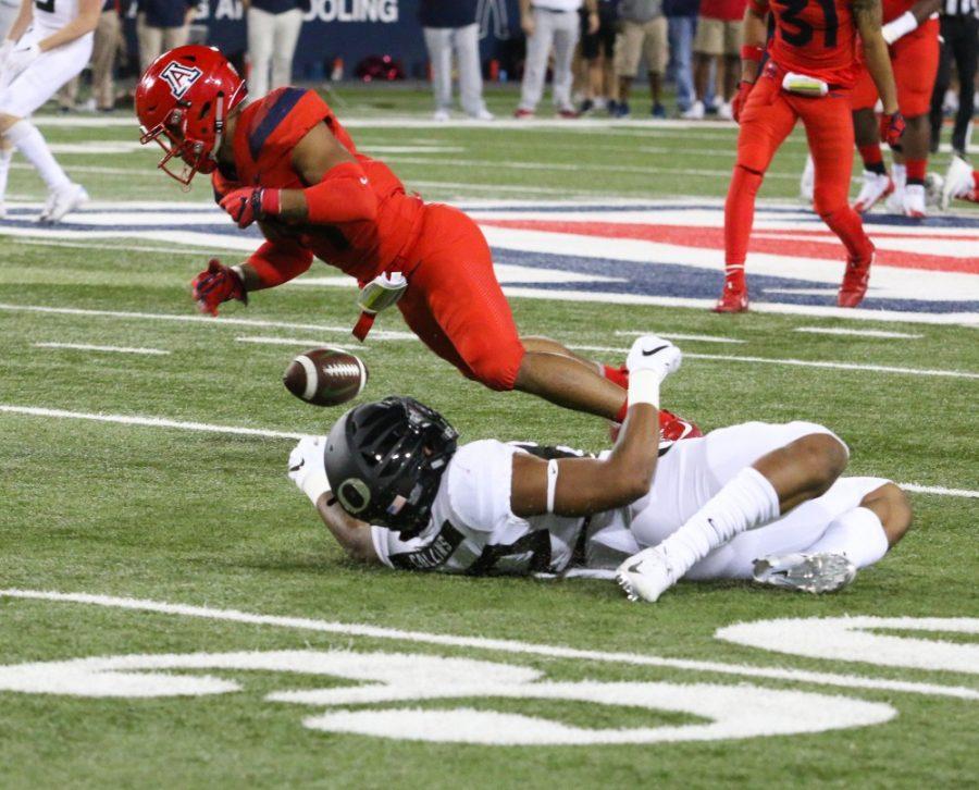 Wide receiver Shawn Poindexter (19) intercepts a pass during the homecoming game against Oregon on Saturday, Oct. 27 at Arizona Stadium. UA won the game 44-15. 