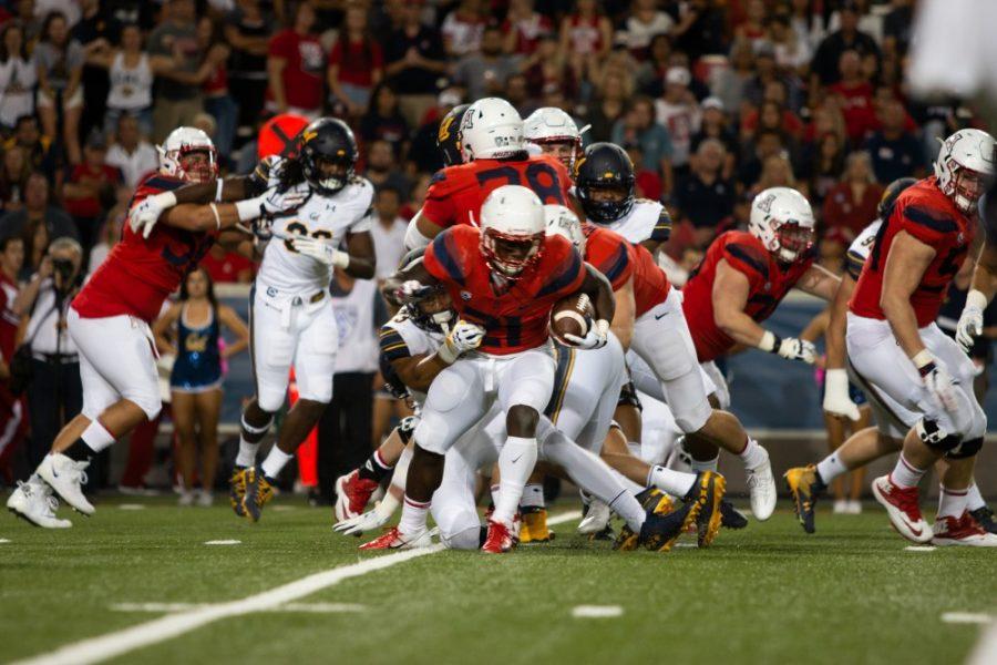 Arizona players runs the ball away from Cal, but is then tackled by their defense on October 6, 2018 in Tucosn, Az. Arizona beat Berkeley 24-17.
