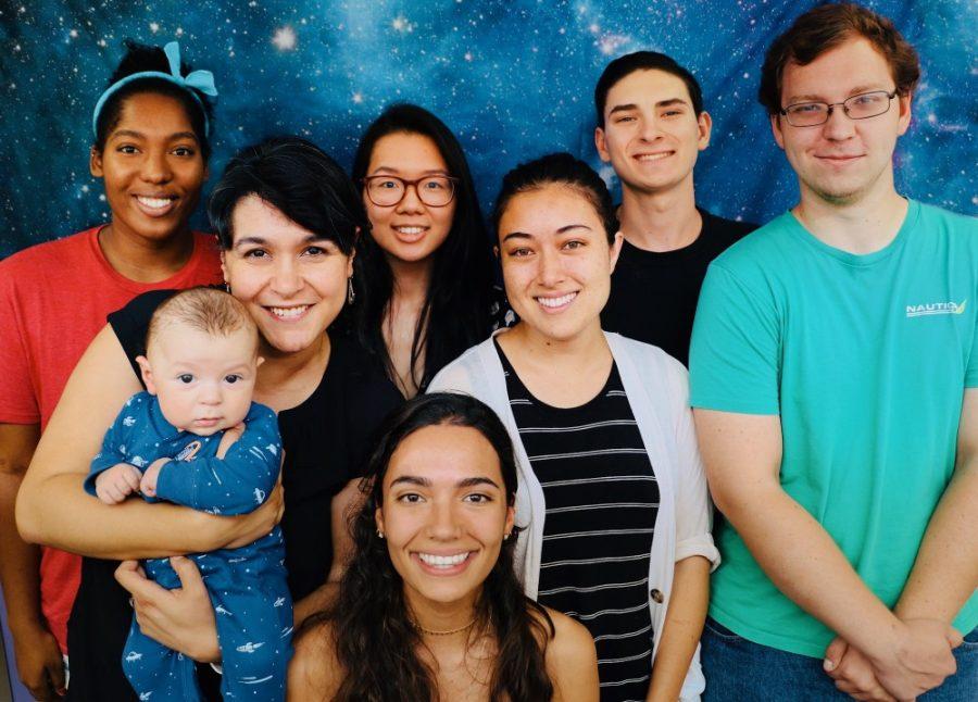 Betul Kacar, second from left, poses with her child and members of the Kacar Lab that studies astrobiology, or the search for the origins of life in the universe.
