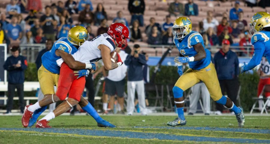 A UCLA player tackles UA wide receiver Shawn Poindexter during the game on Saturday, October 20 at the Rose Bowl. UCLA defeated the cats with a final score of 31-30. 
