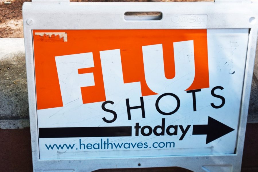 A sign advertising flu shots was placed in front of the University Services Building. This year, Campus Health has surpassed the number of flu shots given out last year.