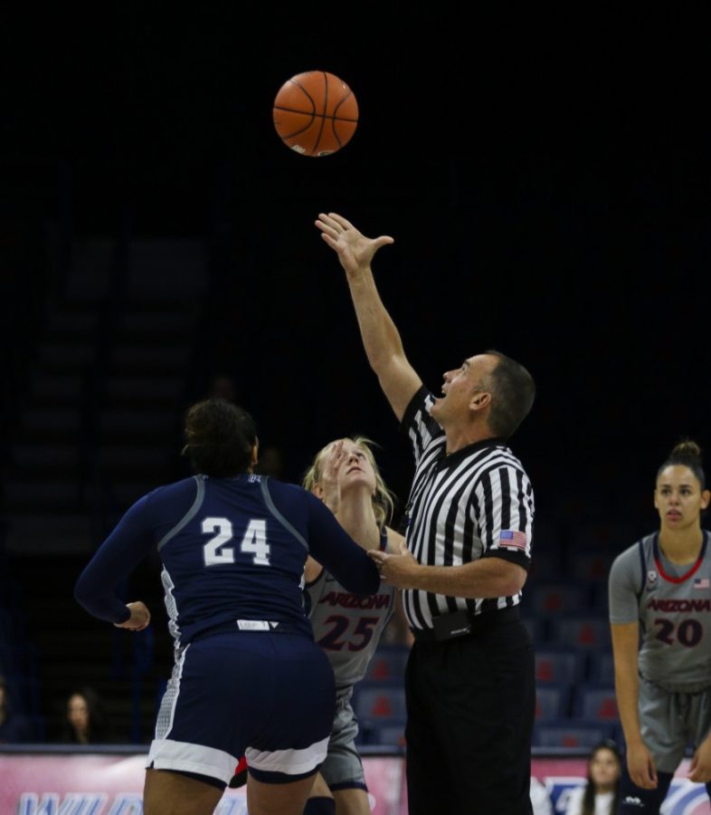 Forward Cate Reese (25) goes for the jump ball that kicks off the match against the Loyola Marymount Lions. UA lost the match 66-64 Tuesday night in the McKale Center.