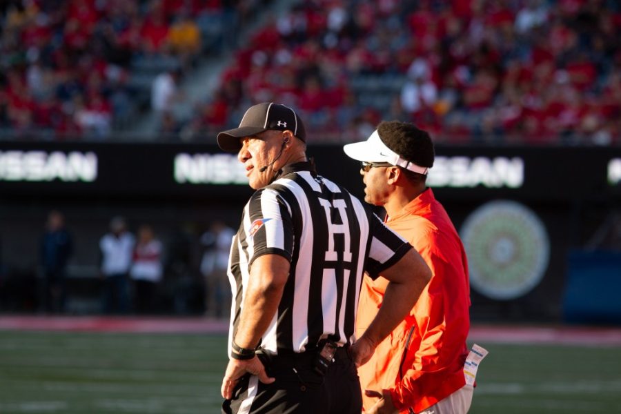 Kevin Sumlin chats with a ref about a play during the game against ASU on Saturday, Nov. 24 at Arizona Stadium. 