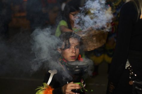 A young girl performs a smoke based ritual on participants that completed the procession. The Tucson All Souls Procession took place on November 4th.