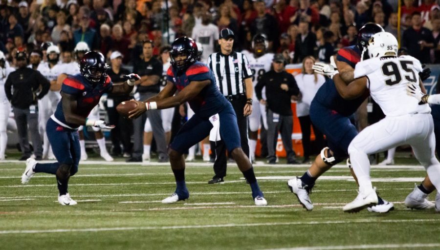 Khalil Tate (14) hands off the ball to J.J. Taylor (21) during the first quarter of the Arizona-Colorado game on Nov. 2, 2018 at Arizona Stadium in Tucson, Az. At the end of the half Wildcats lead 26-24.