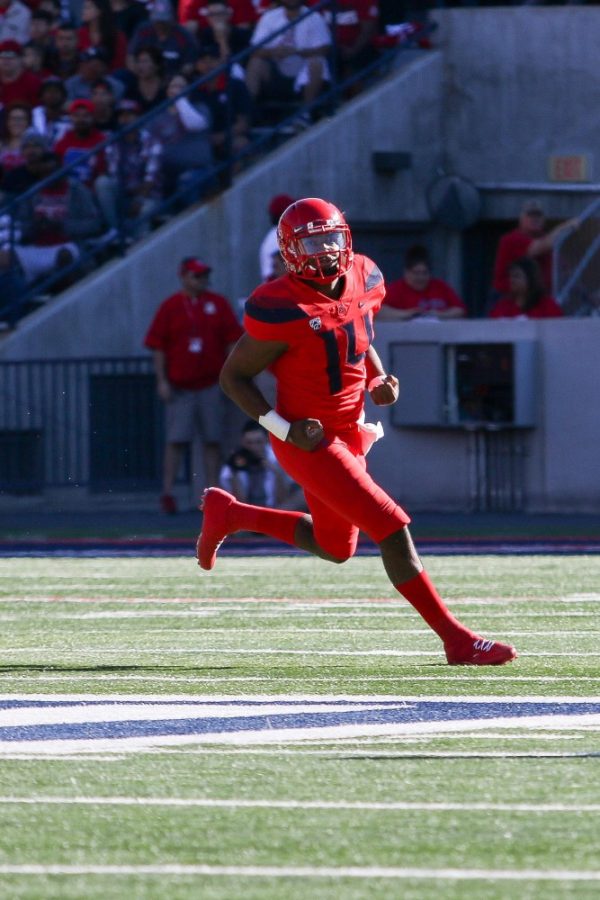Junior quarterback Khalil Tate (14) veers left after the Wildcats moved down the field against Arizona State on November 24th.