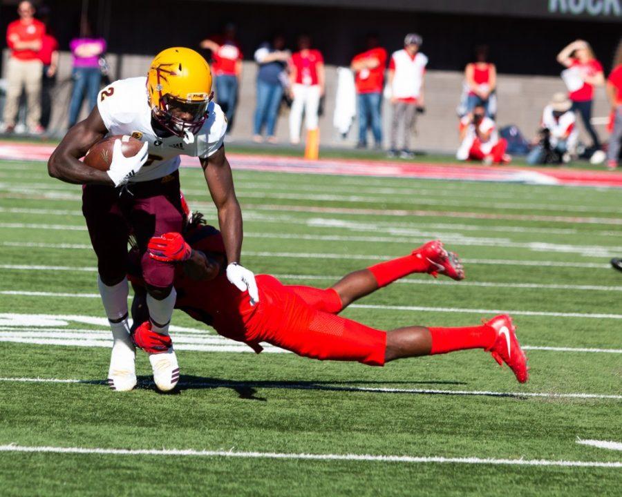 Safety Demetrius Flannigan-Fowles (6) tackles an ASU player during the game on Saturday, Nov. 24 at Arizona Stadium. The Devils beat the Cats and took home the territorial cup with a score of 41-40. 