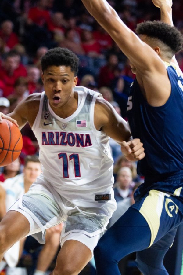 Forward Ira Lee (11) drives past a UC Davis player during the game on Saturday, Dec. 22 at McKale Center. Arizona won 70-68. 