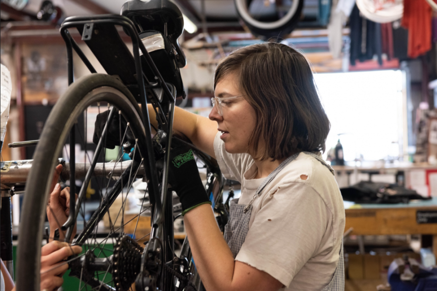 Diana Englert works on a bike Monday during the women, transgender, and femme workshop at Bicycle Inter-Community Art and Salvage (BACA).