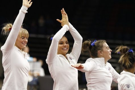 UA gymnasts Alivia Kendrick, Adra Parks, and Maddi Leydin celebrate after their team wins first place during the UA v California meet on Jan. 26 in McKale Center.