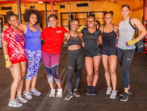 Members of the Black Girls' Fitness Club smile after successfully completing the first BFIT group class. 