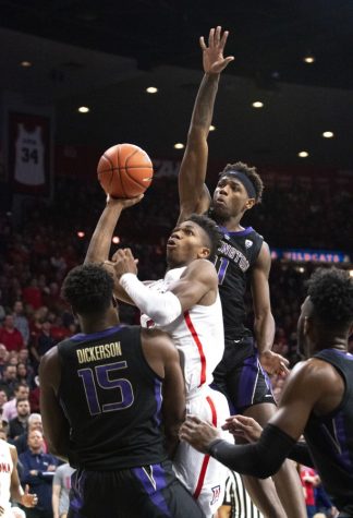 Arizona guard Brandon Randolph (5) throws the ball towards the net while being defended by Washington. At the end of the game, the Wildcats lost 67-60.