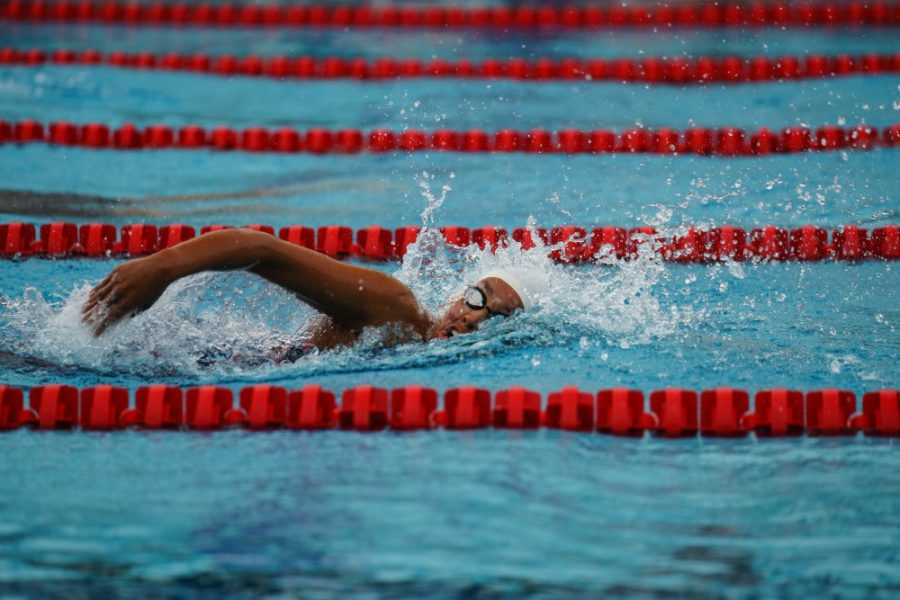 A member of the Arizonas Women Swim Team swims done the pool during the first meet of the day. 