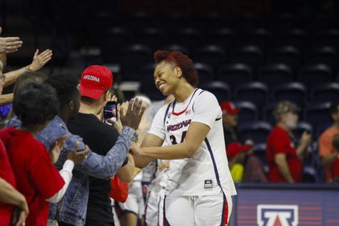 Arizona's freshman center, Semaj Smith high-fiving fans after the game against the Pacific Tigers on Sunday, March 24, 2019. The final score of the game was 64-48, a win for the Wildcats.