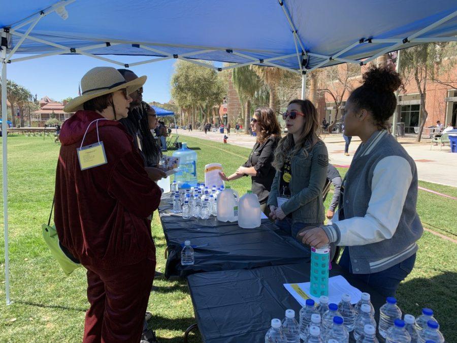 At the  second annual Walk a Mile in a Refugees Shoes simulation event workers like Imani Cruz (right) educated people on the refugee experience. Te event took place Thursday, March 14, on the University of Arizona Mall. 