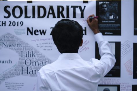 Students write messages to the victims of New Zealand's Christchurch shooting on Mar. 20. The vigil was put on by the Muslim Student Association and the Univeristy Religious Council at the University of Arizona.