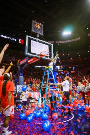 Coach Adia Barnes cuts the championship net after the women's basketball team beat out Northwestern on Apr. 6 in Tucson, Ariz.