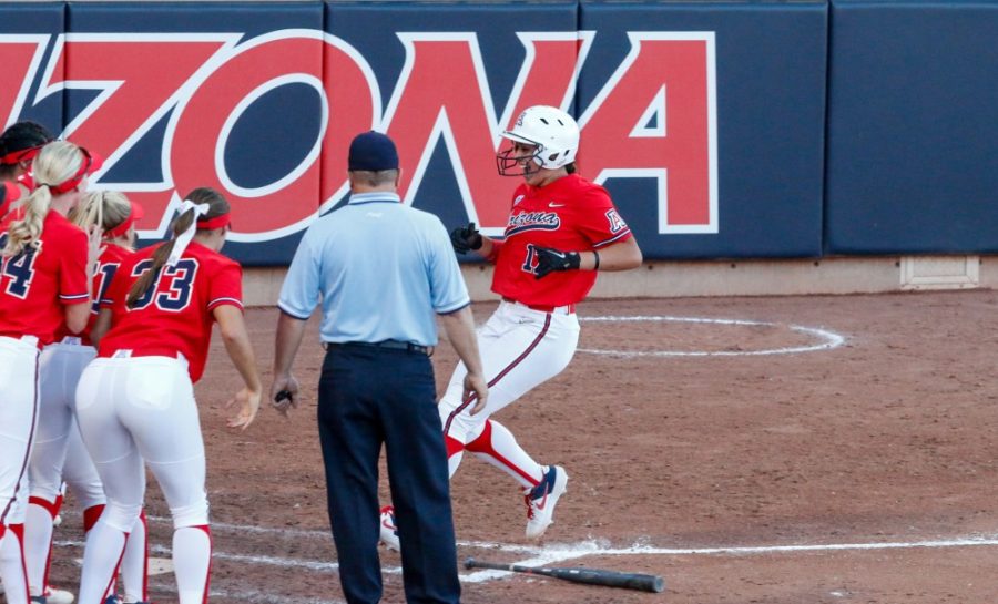 The+team+crowds+the+home+plate+to+welcome+in+Malia+Martinez+%2817%29+after+she+hits+a+home+run.+The+game+on+May+25th%2C+2019+resulted+in+the+Wildcats+beating+Ole+Miss+9-1+and+advancing+to+the+Womens+College+World+Series.+