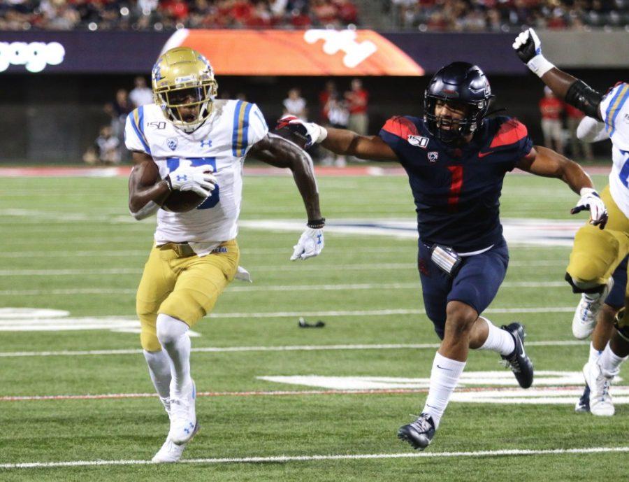 Wildcat Tony Fields II (1) runs after UCLA wide receiver Jaylen Erwin (15) during the Arizona-UCLA game on September 28, 2019. The Wildcats defeated the Bruins 20-17. 