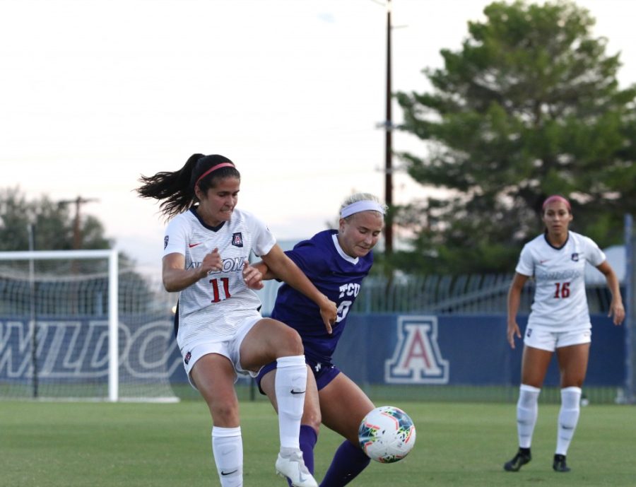 Arizona defender, Morgan McGarry (11) tries to get the ball away from TCUs forward. 