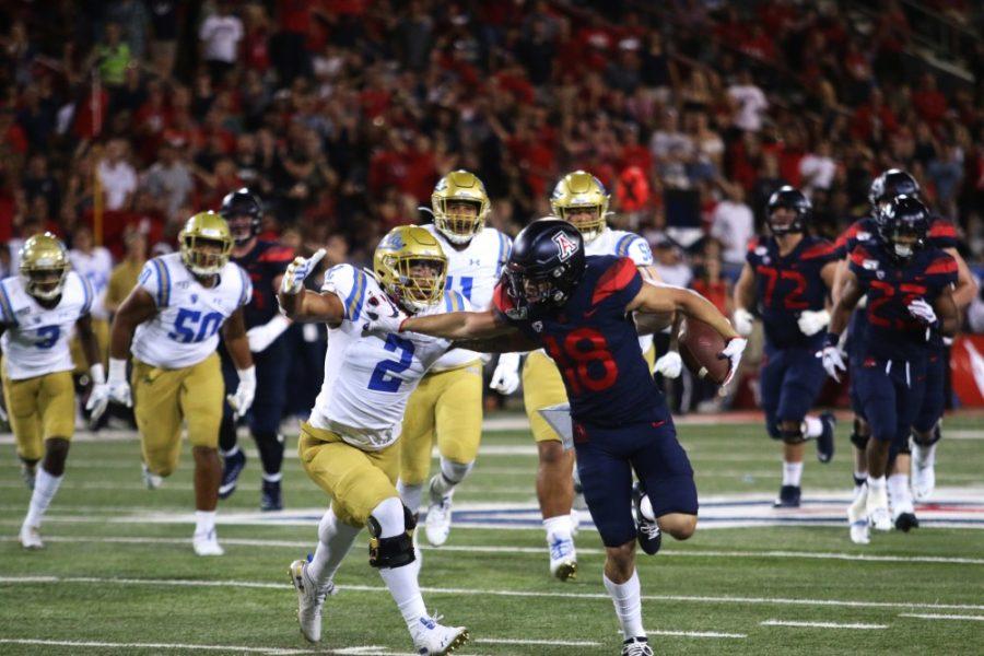 Arizona+wide+receiver+Cedric+Peterson+%2818%29+runs+down+the+field+while+being+chased+by+UCLAs+Josh+Woods+%282%29.+The+Wildcats+defeated+the+Bruins+20-17.