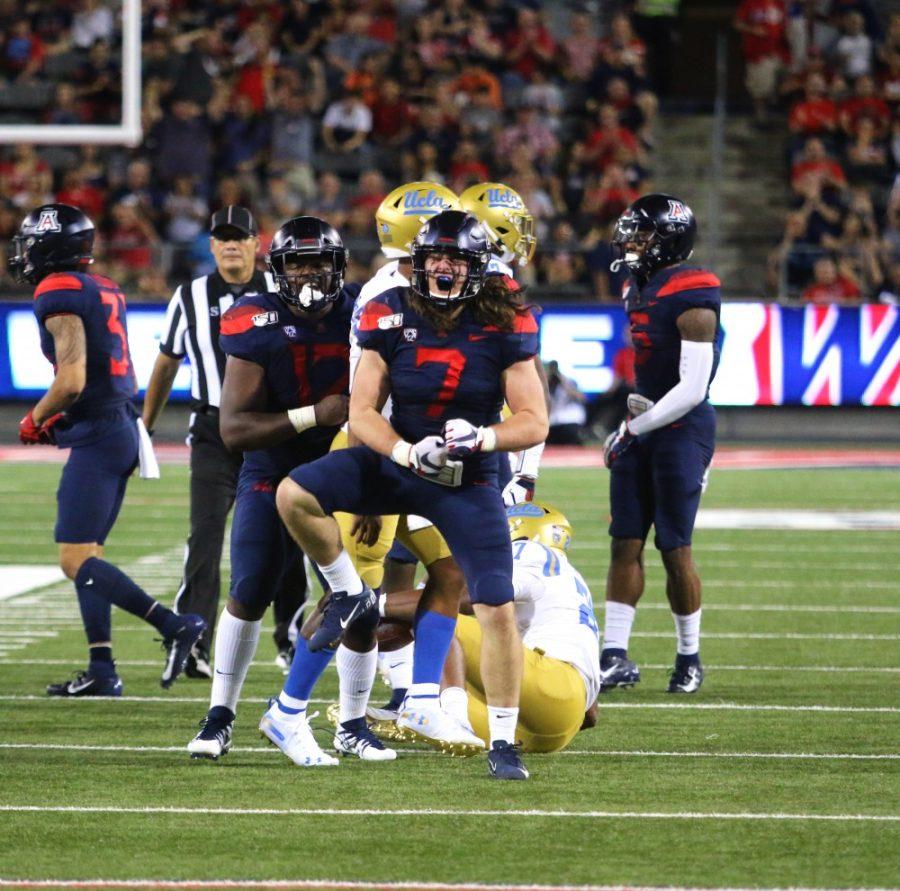 Wildcat Colin Schooler (7) celebrates after blocking UCLA player from gaining another yard during the Arizona-UCLA game on September 28. At halftime, UCLA leads 7-6. 