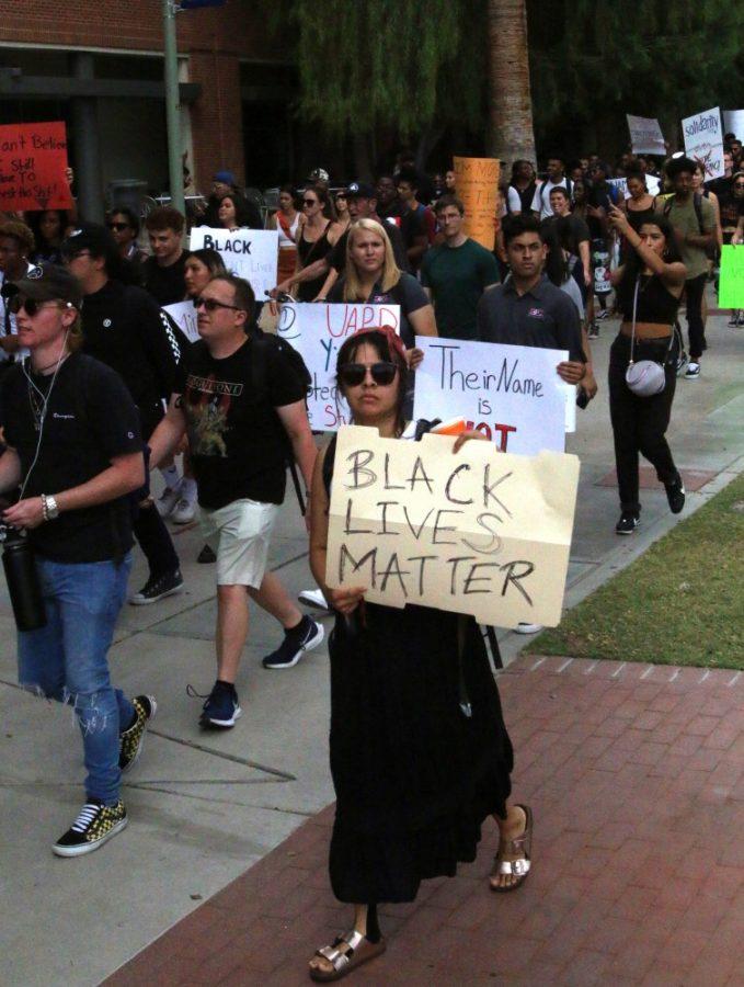 On+Friday+September+13%2C+the+Black+Student+Union+gathered+in+front+of+the+Administration+building+to+protest+the+injustice+that+occurred+on+Tuesday.+Protesters+held+up+signs+and+wore+black+to+signify+their+solidarity+of+the+victim.+